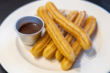 fried-dough pastry—predominantly choux—based snack churros with Chocolate Syrup