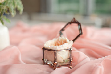 Wedding decor vintage glass square box with peony rose inside and wedding ring invitation card.