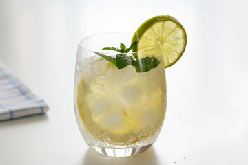 Mineral water with lemon in a steaming glass