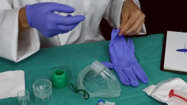 Nurse prepares medication for aerosols in a hospital, conceptual image