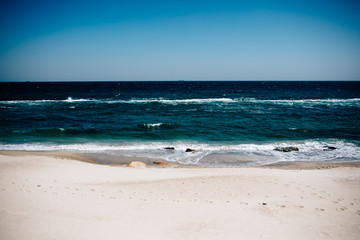 Seascape of deserted sandy beach