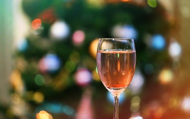 Glass of wine closeup Christmas bokeh light interior