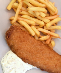 Knuspriges Seelachsfilet mit goldgelben Pommes frites und Remoulade