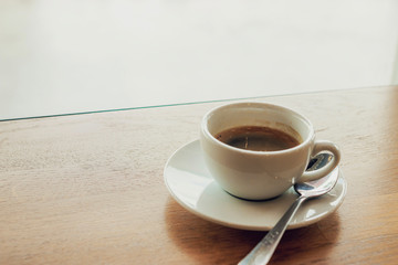 Cup of coffee cappuccino on wooden bar in cafe.