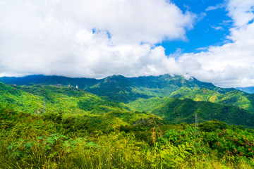 Obraz premium Blue sky high peak mountains fog hills mist scenery national park views at Phu Tub Berk, Khao Koh, Phetchabun Province, Thailand