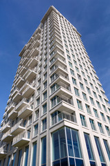 Fototapeta na wymiar Contemporary white residential tower against a blue sky