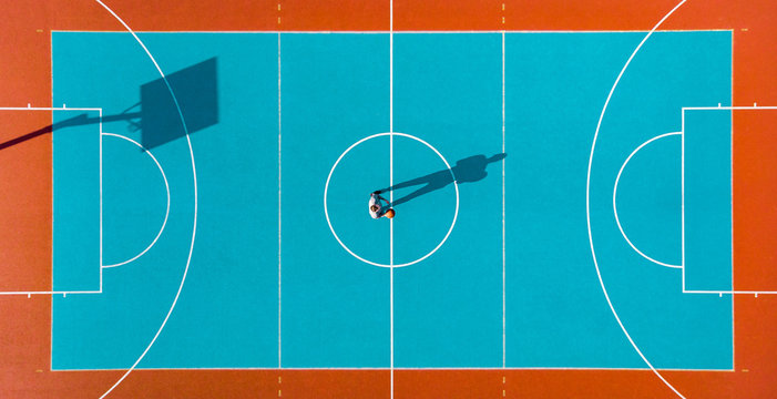 Basketball Player, Long Shadows on Basketball Court, Creative Visual Art, Aerial Image