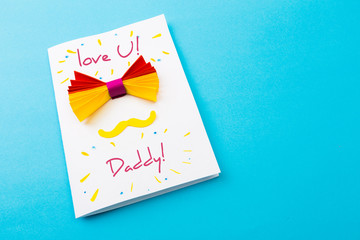 Happy fathers day sign on paper  laid on blue backround.