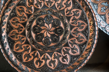 Copper plate handcrafted, traditionally made in Lagich, Azerbaijan. Handmade plate in souvenir shop.