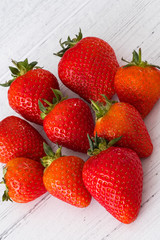 A Pile Of Healthy Scottish Strawberries on a White Plank Board.