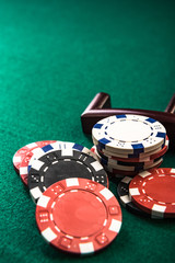 Poker or Roulette Casino Chips Close Up on Green Felt Casino Table