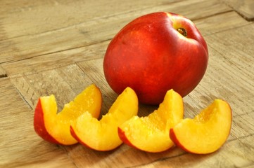 red nectarine on wooden background