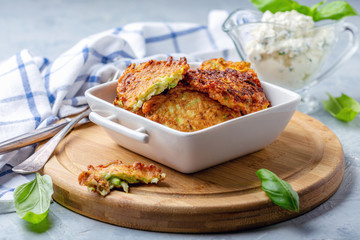 Zucchini pancakes with sour cream sauce.