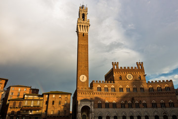 Fototapeta premium Torre del Mangia, clock tower of a city hall on Piazza del Campo main square in Siena, Tuscany, Italy