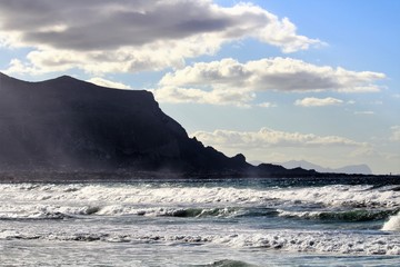 rescue boat on the beach with cape in the background