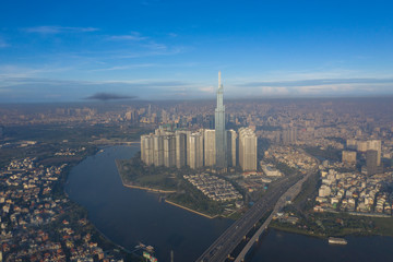 Top View of Building in a City - Aerial view Skyscrapers flying by drone of Ho Chi Mi City with development buildings, transportation, energy power infrastructure. include Landmark 81 and blue sky ,