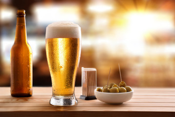 Appetizer with glass beer on wooden slatted table in pub - Powered by Adobe