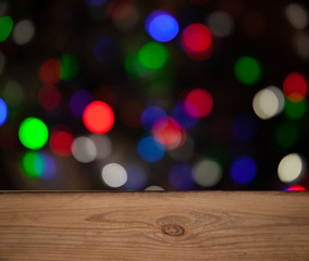 blurred background of light bulbs with wooden table
