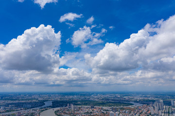 Top View of Building in a City - Aerial view Skyscrapers flying by drone of Ho Chi Mi City with development buildings, transportation, energy power infrastructure. include Landmark 81 and blue sky ,