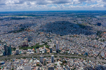 Top View of Building in a City - Aerial view Skyscrapers flying by drone of Ho Chi Mi City with development buildings, transportation, energy power infrastructure. include Landmark 81 and blue sky ,