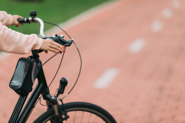 woman cyclist riding a bike on bike path, close-up