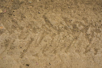 Imprint of a car tire in the sand. Extruded relief