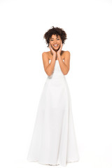 Fototapeta na wymiar happy african american bride smiling while standing in wedding dress isolated on white