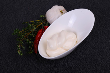 Fototapeta na wymiar Mayonnaise sauce in the white bowl served thyme and garlic