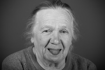 Portrait of elderly woman. Shows tongue. Toned