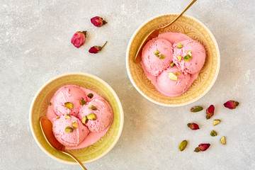 Fototapeta na wymiar Strawberry rosewater ice cream , frozen yogurt with pistachio and rosebud. Top view 