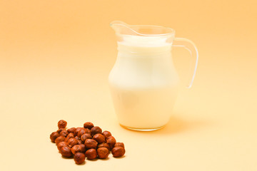 Hazelnut milk in a jar and nuts.