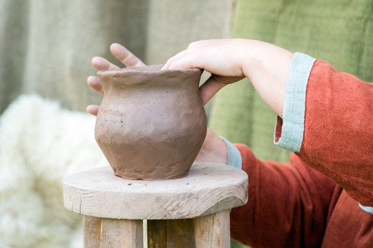 Womens wearing rural traditional clothes hand making ceramic cla