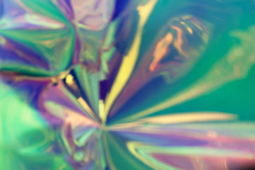 Blurred photo of a trendy abstract colorful holographic material. Futuristic concept.