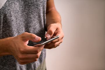 Close up shot of man's hands holding smart cell phone with blank