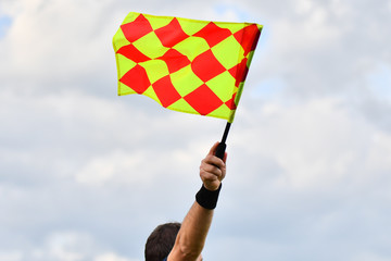 Assistant referee or Lineman of football or soccer holding flag