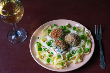 Pasta with meatballs on a dark background