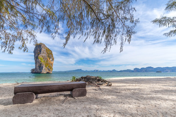 Beach chairs and palms on the beautiful beach for holidays and relaxation at Poda island, Thailand