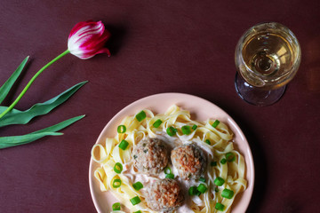 Pasta with meatballs on a dark background