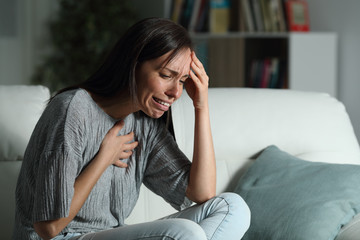 Sad woman with broken heart complaining at home