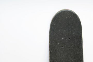 Front top of a skateboard deck with grip tape and bolt holes on