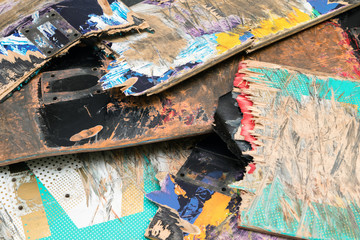 Broken colourful skateboard decks stacked on top of each other,