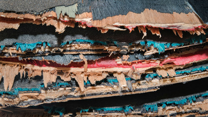 Broken colourful skateboard decks stacked on top of each other,