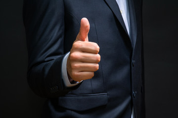 Business man shows thumb up sign gesture. Successful business de