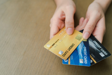Closeup Asian beautiful woman Wearing a black shirt Sitting in the house Have a credit card in hand Is buying online products with a laptop computer