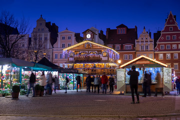 Beautiful illuminated wooden pavilion at traditional Christmas market at Wroclaw. Night time. Poland