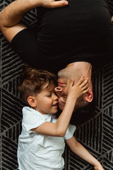 Smiling boy playing with his Dad