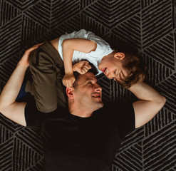 Smiling boy playing with his Dad