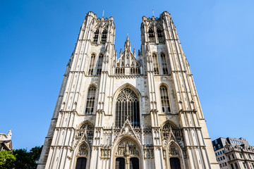 Fototapeta na wymiar The western facade of the Cathedral of St. Michael and St. Gudula in Brussels, Belgium, with its three portals surmounted by gables and two towers, is typical of the French Gothic style.