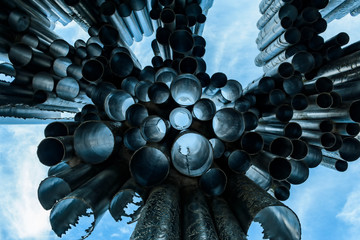 beautiful postcard monument with a bright blue sky on background. abstract silver tubes with...