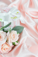 Festive composition with roses and gift box